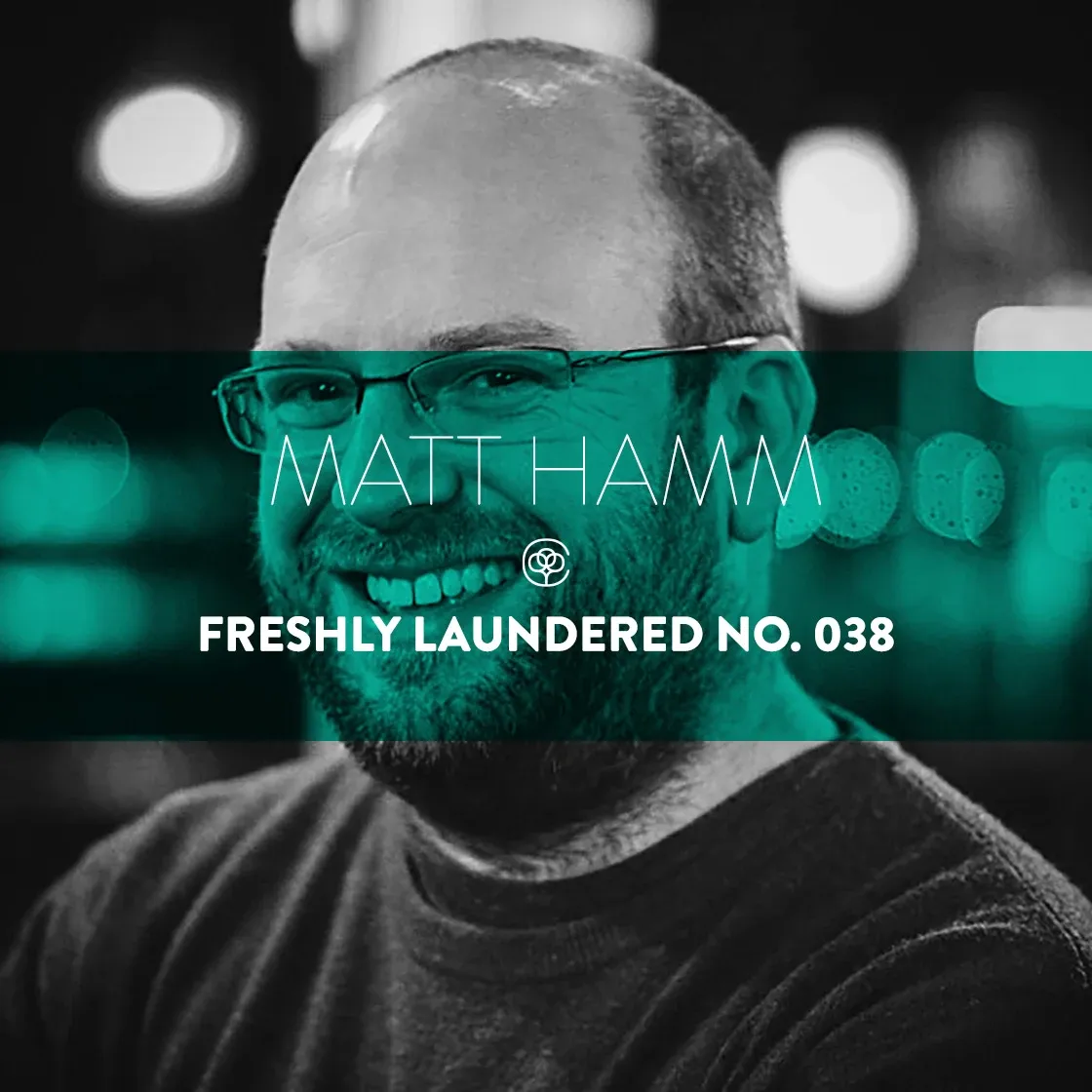 Black and white portrait of Matt Hamm with a teal band reading Matt Hamm, Freshly Laundered No. 038